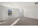 A sunlit bedroom with large carpet and two windows at 413 Citron St, Sanford, NC 27332
