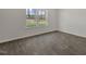 A bright bedroom with large window offering views of the wooded landscape at 413 Citron St, Sanford, NC 27332