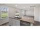Kitchen with stainless steel appliances, granite counters, white cabinets, and an open layout to the living room at 413 Citron St, Sanford, NC 27332