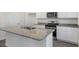 Kitchen featuring white cabinets, granite countertops, stainless steel appliances, and a spacious island with a sink at 413 Citron St, Sanford, NC 27332