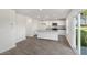 Bright kitchen featuring an island with granite countertop, white cabinets, and stainless steel appliances at 413 Citron St, Sanford, NC 27332