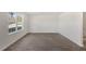 Sunlit living room featuring large windows and luxury vinyl plank flooring at 413 Citron St, Sanford, NC 27332