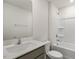 Bathroom features a light-colored vanity, framed mirror, and a shower-tub combination with white tiling at 417 Citron St, Sanford, NC 27332
