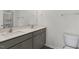 Bathroom with double sink vanity, large mirror and white toilet at 417 Citron St, Sanford, NC 27332