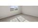 Bedroom showcasing the neutral carpeting and a window providing natural light and outdoor views at 417 Citron St, Sanford, NC 27332