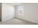 Clean bedroom features neutral carpet and paint and a window providing natural light at 417 Citron St, Sanford, NC 27332