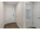 Inviting entryway showcasing hardwood flooring, a coat closet, and entry to a carpeted bedroom at 417 Citron St, Sanford, NC 27332