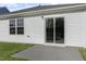 Home exterior featuring sliding glass doors that lead to an outdoor patio and a double-hung window at 417 Citron St, Sanford, NC 27332