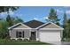 Charming single-story home featuring gray siding, a two-car garage, and beautifully landscaped front yard at 417 Citron St, Sanford, NC 27332