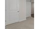 Hallway featuring a light colored carpet, two white painted doors, and base trim at 417 Citron St, Sanford, NC 27332