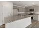 Kitchen featuring a central island with a sink and gray cabinets, with stainless appliances, and stone countertops at 417 Citron St, Sanford, NC 27332
