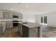 Open kitchen featuring a central island with a sink and views into the living room with outdoor access at 417 Citron St, Sanford, NC 27332