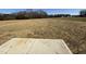 Large backyard, with a wooded treeline, offering privacy and a sense of openness at 44 Harvest Hills Ln, Dunn, NC 28334