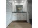 Bathroom with a granite double vanity, complemented by wood-look flooring, and modern hardware at 44 Harvest Hills Ln, Dunn, NC 28334