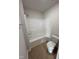 Clean bathroom featuring a shower-tub combination and a modern toilet fixture at 44 Harvest Hills Ln, Dunn, NC 28334