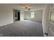 Spacious bedroom features a ceiling fan, window for natural light, and neutral carpeting at 44 Harvest Hills Ln, Dunn, NC 28334