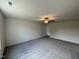 A large bedroom has neutral carpeting and a ceiling fan, leading to the ensuite bathroom at 44 Harvest Hills Ln, Dunn, NC 28334