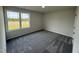 Comfortable bedroom with neutral walls, plush carpeting, and a bright, sunny window at 44 Harvest Hills Ln, Dunn, NC 28334