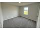 Cozy bedroom featuring neutral walls, plush carpeting, and a large, bright window at 44 Harvest Hills Ln, Dunn, NC 28334
