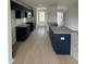 Bright, open kitchen with dark cabinets, granite counters, and luxury vinyl plank flooring at 44 Harvest Hills Ln, Dunn, NC 28334