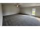 Bright living room featuring neutral walls, plush carpeting, and a ceiling fan at 44 Harvest Hills Ln, Dunn, NC 28334