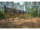 A view of the home's exterior and backyard with mature trees from the natural landscape at 5008 Hermitage Dr, Raleigh, NC 27612