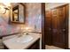 Classic bathroom featuring decorative wallpaper, a stylish mirror, and vanity lighting at 5008 Hermitage Dr, Raleigh, NC 27612