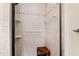 Shower with tiled walls, built in shelving and a corner bench at 5008 Hermitage Dr, Raleigh, NC 27612
