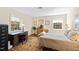 Bright bedroom with an ornate desk, wood floors and natural light streaming through the windows at 5008 Hermitage Dr, Raleigh, NC 27612