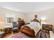 Charming bedroom featuring antique furniture, wood floors, a large window, and cozy decor at 5008 Hermitage Dr, Raleigh, NC 27612