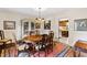 Charming dining room featuring a chandelier, hardwood floors, and adjacent butler's pantry at 5008 Hermitage Dr, Raleigh, NC 27612