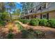 Well-maintained brick home with dormer windows and a walkway lined with lush greenery at 5008 Hermitage Dr, Raleigh, NC 27612