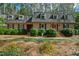 Beautiful brick home with a gray roof, black shutters and meticulously manicured greenery at 5008 Hermitage Dr, Raleigh, NC 27612