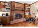 Close-up of brick fireplace with decorative mantle and built-in bookshelves at 5008 Hermitage Dr, Raleigh, NC 27612