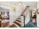 Classic foyer with a staircase, traditional decor, and hardwood accents at 5008 Hermitage Dr, Raleigh, NC 27612
