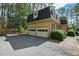 Attached two-car garage with a spacious driveway, set amidst beautiful greenery at 5008 Hermitage Dr, Raleigh, NC 27612