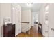 Bright hallway with hardwood floors, neutral paint, and access to other rooms at 5008 Hermitage Dr, Raleigh, NC 27612