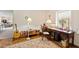 Well-lit home office with a wooden desk, vintage touches, and large windows at 5008 Hermitage Dr, Raleigh, NC 27612