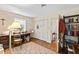 Bright home office featuring a wood desk, ample lighting, and a view of the outdoors at 5008 Hermitage Dr, Raleigh, NC 27612