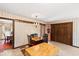 Eat-in kitchen with tile flooring, wood cabinets, and access to the dining room at 5008 Hermitage Dr, Raleigh, NC 27612