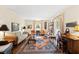 Bright living room with hardwood floors, ornate rug, and comfortable seating arrangement at 5008 Hermitage Dr, Raleigh, NC 27612