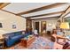 Spacious living room with exposed beams, hardwood floors, and an open layout at 5008 Hermitage Dr, Raleigh, NC 27612