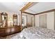Elegant main bedroom with hardwood floors, a four-poster bed, and tasteful decor at 5008 Hermitage Dr, Raleigh, NC 27612