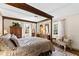 Spacious main bedroom featuring a four-poster bed, hardwood floors, and plenty of natural light at 5008 Hermitage Dr, Raleigh, NC 27612