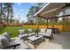 Backyard features patio seating, a covered area, and a well-maintained lawn at 505 Colleton Rd, Raleigh, NC 27610