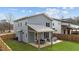 Inviting backyard with a covered patio, outdoor dining and seating, surrounded by a well-maintained lawn at 505 Colleton Rd, Raleigh, NC 27610