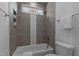 A charming bathroom with a tiled shower and a window for natural light at 505 Colleton Rd, Raleigh, NC 27610
