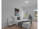 A bright, minimalist bedroom with hardwood floors, soft lighting, and two windows at 505 Colleton Rd, Raleigh, NC 27610