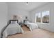 Bright, minimalist bedroom with two twin beds, hardwood floors, and a large window at 505 Colleton Rd, Raleigh, NC 27610