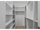 Walk-in closet with white built-in shelving and a wooden hanging rack at 505 Colleton Rd, Raleigh, NC 27610